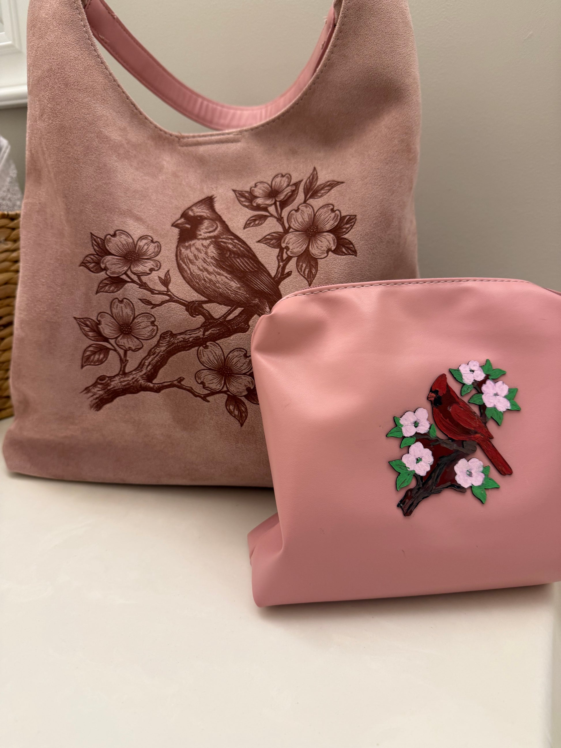 Beautiful cardinal hanging out on a branch of a Dogwood tree made by Beach Vibes NC/Crystal Coast Cowgirl Set of 3 items large brim faux suede heart shaped hat, large faux suede pink handbag and makeup bag.