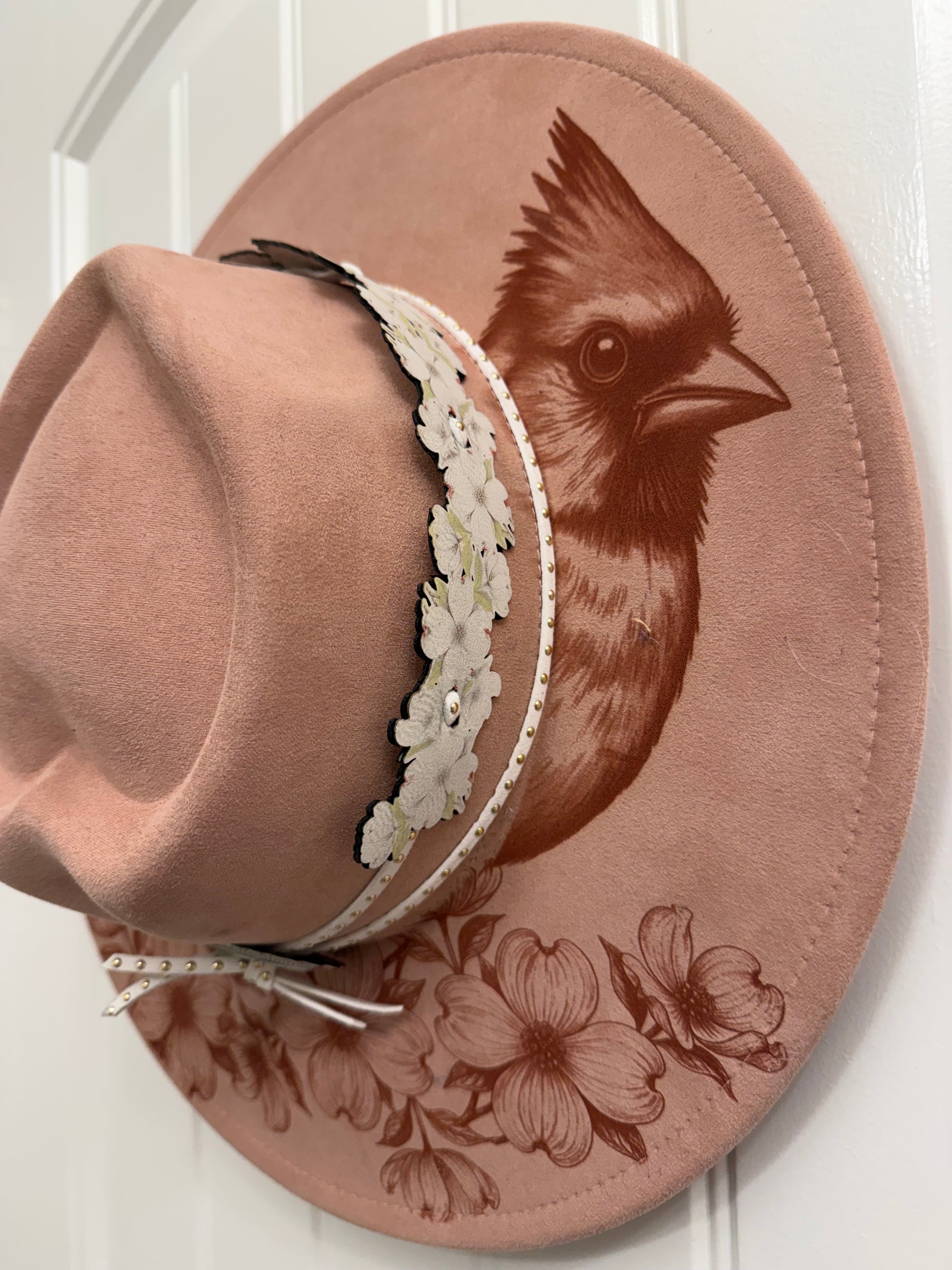 Beautiful cardinal hanging out on a branch of a Dogwood tree made by Beach Vibes NC/Crystal Coast Cowgirl Set of 3 items large brim faux suede heart shaped hat, large faux suede pink handbag and makeup bag.